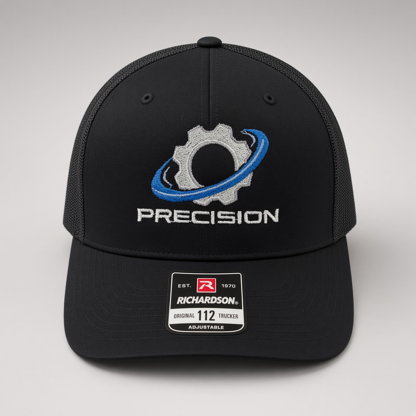 Black Richardson trucker cap with embroidered Precision gear and orbit logo