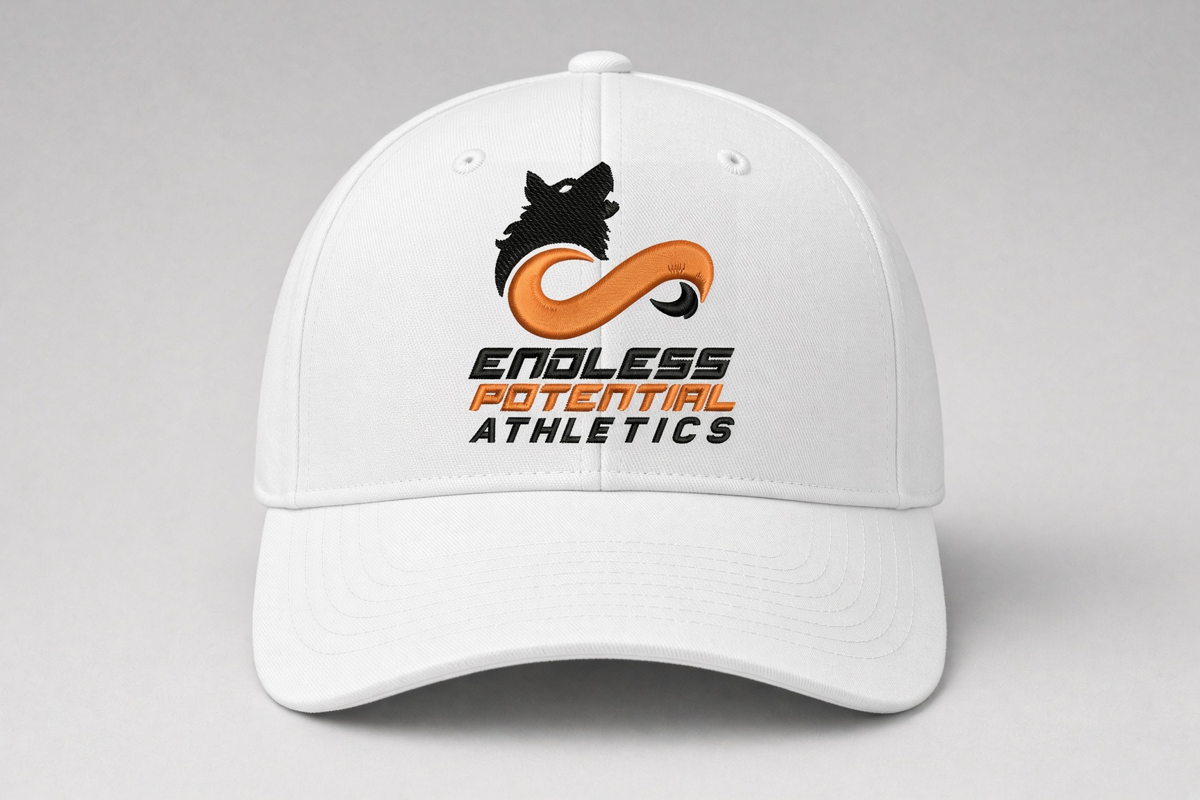 White baseball cap with the Endless Potential Athletics wolf logo